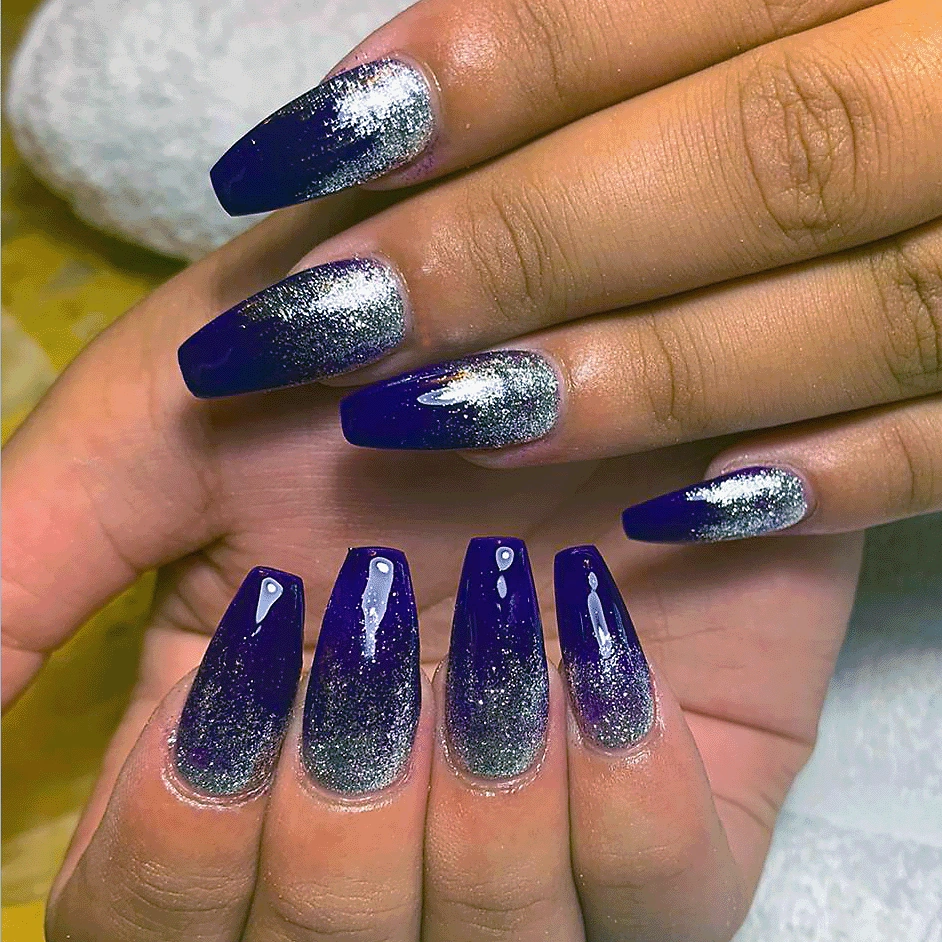 Coffin-shaped acrylic nails with a navy blue to silver glitter ombré.