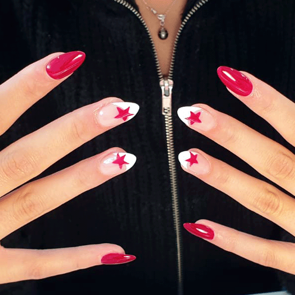 Hands with red almond-shaped nails, three nails on each hand have white tips with red star designs.