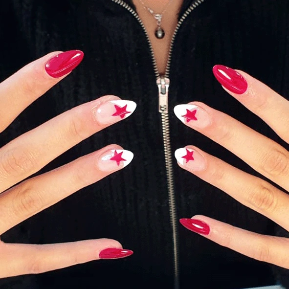 Hands with red almond-shaped nails, three nails on each hand have white tips with red star designs.