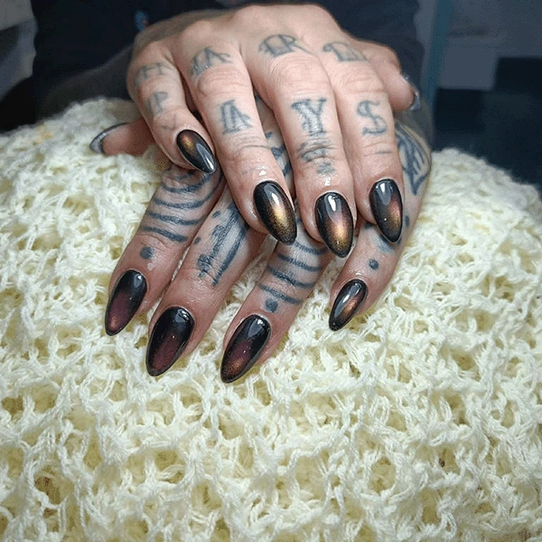 Almond nails with a dark chrome cat-eye finish.